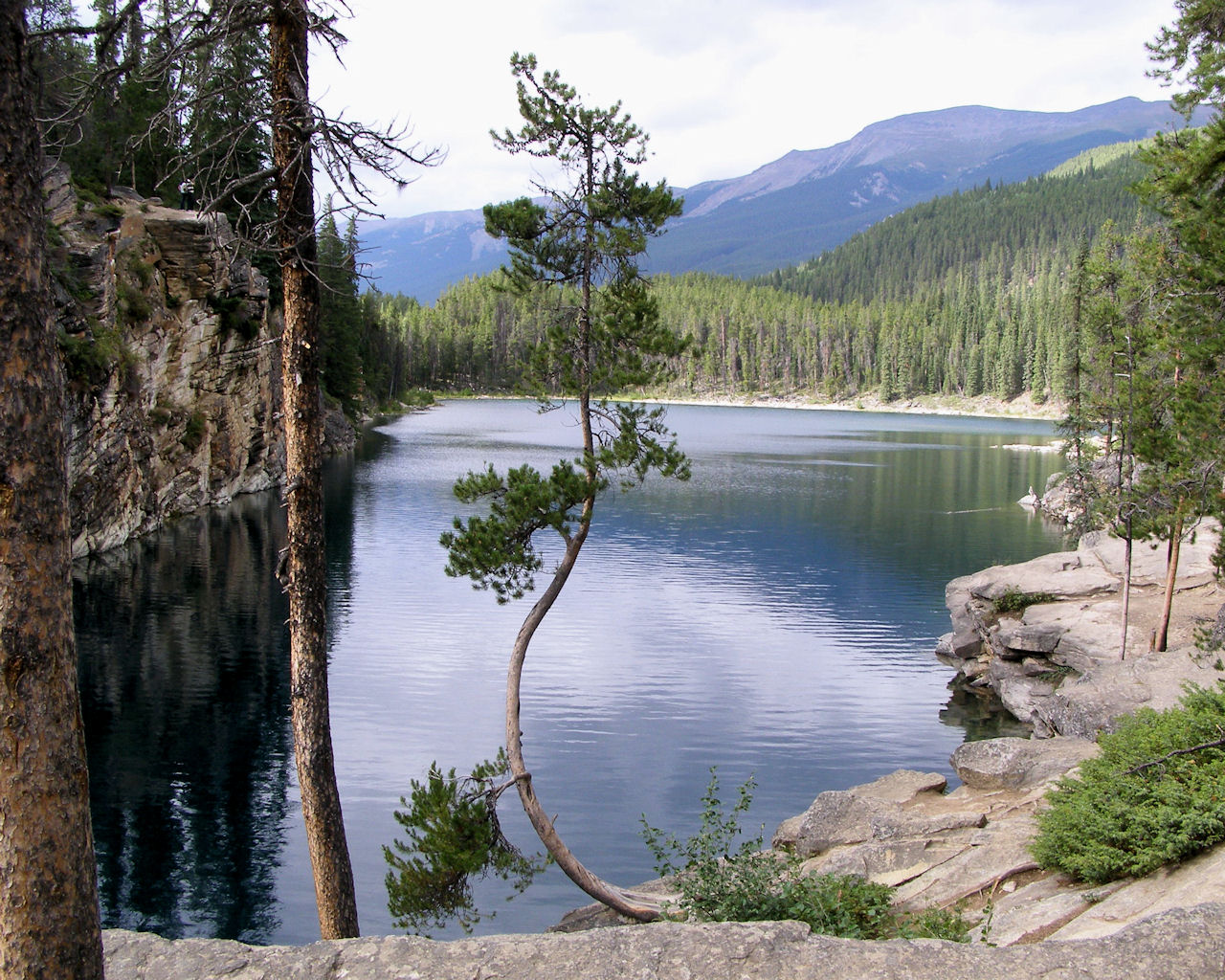 Mountain lake surrounded by forest and rock