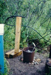 Water being delivered into a pail by the ram pump